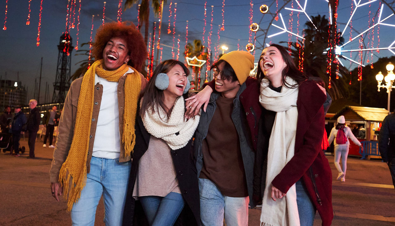 Group of best friends hanging out together at an amusement park in the winter