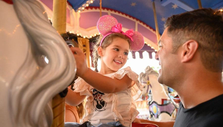 father and daughter on carousel