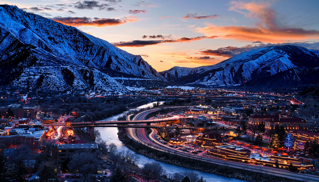 Glenwood Springs at Dusk with Colorado River View - Colorado River flowing through the heart of Glenwood Springs Colorado at dusk during blue hour. Sunset skies.