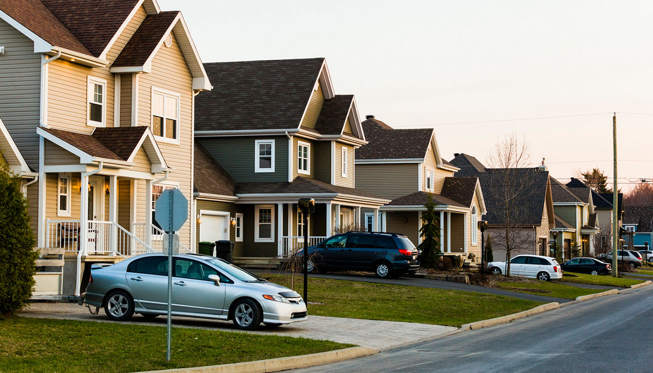 Homes in a row. Suburb. family car. Driveway.