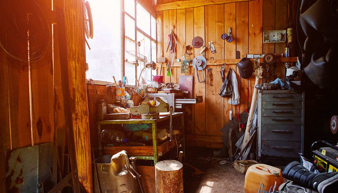 An old wooden garage with various tools and equipment