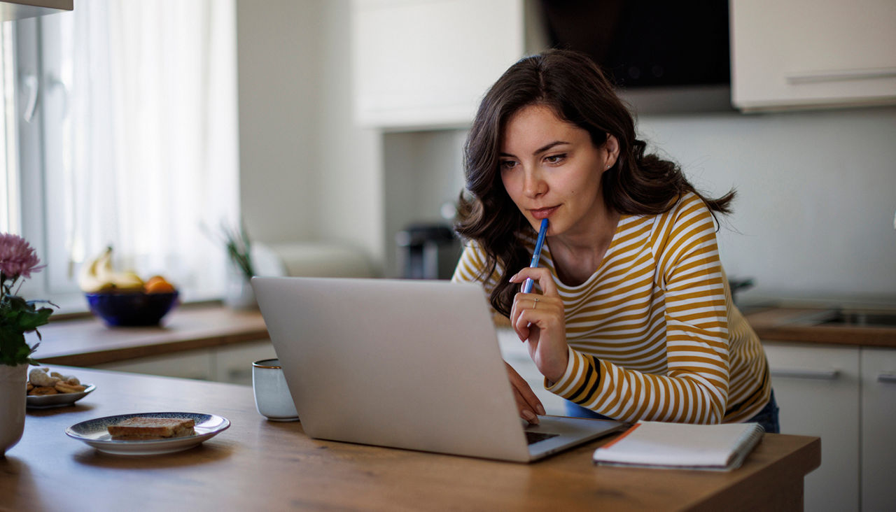 Young woman using a laptop while working from home