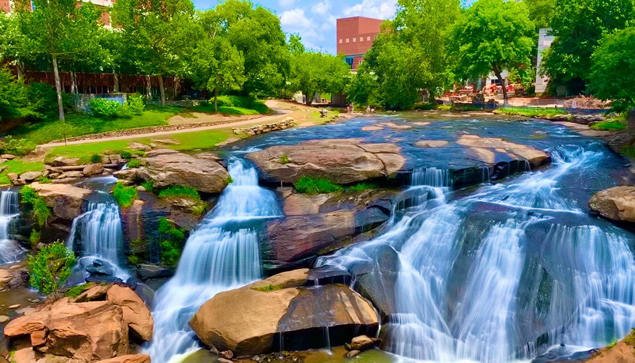 Waterfall in the middle of downtown Greenville, South Carolina with building in the background