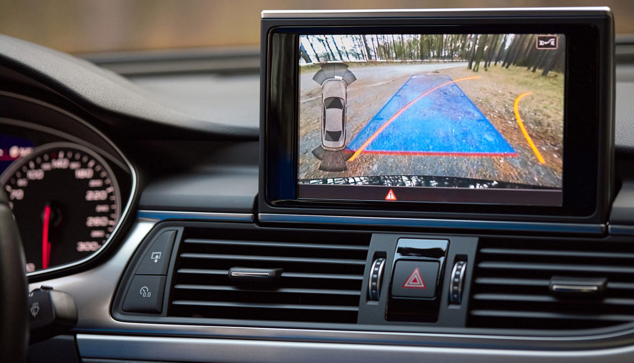 A dashboard video screen monitor showing what is behind a car.