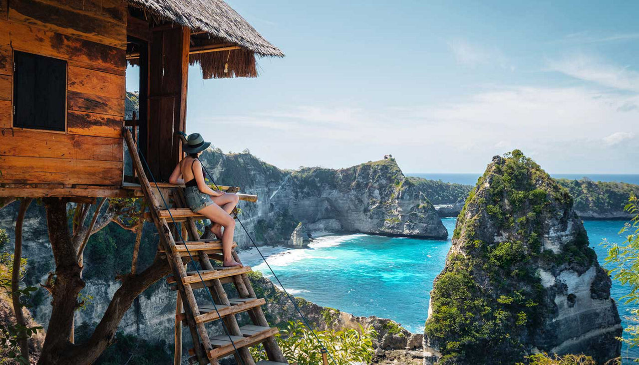 Traveler on Treehouse overlooking Diamond Beach, Nusa Penida Island, Bali, Indonesia