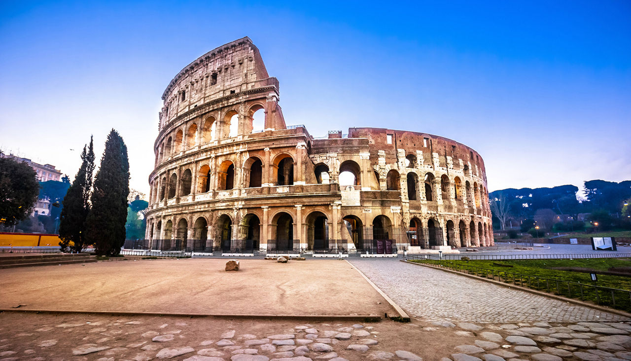 Rome. Empty Colosseum square in Rome dawn view, the most famous landmark of eternal city, capital of Italy