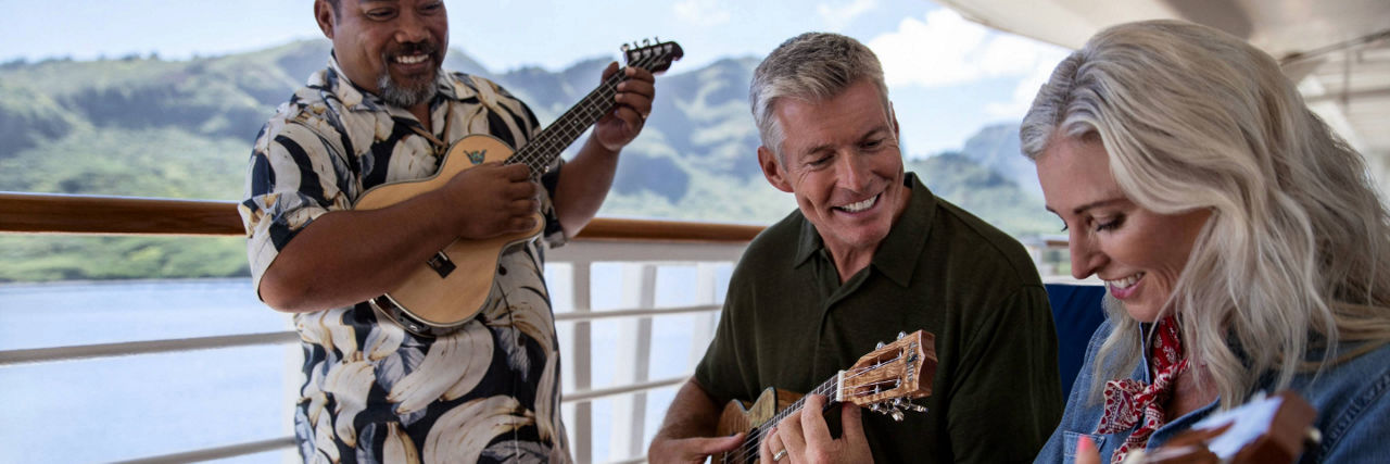 Couple on cruise ship learning how to play the ukulele