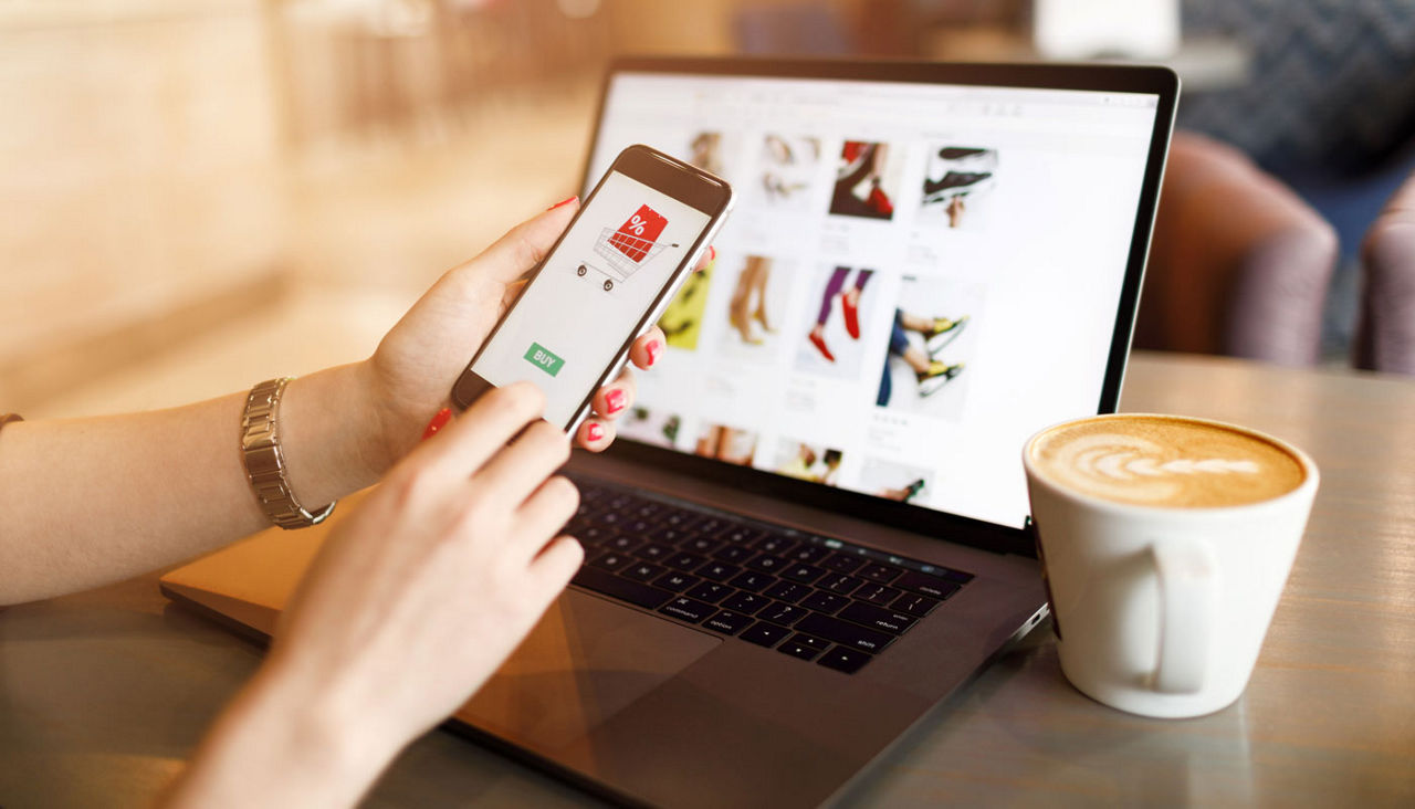 Women hands using smartphone and laptop computer for online shopping. Payment Detail page display.