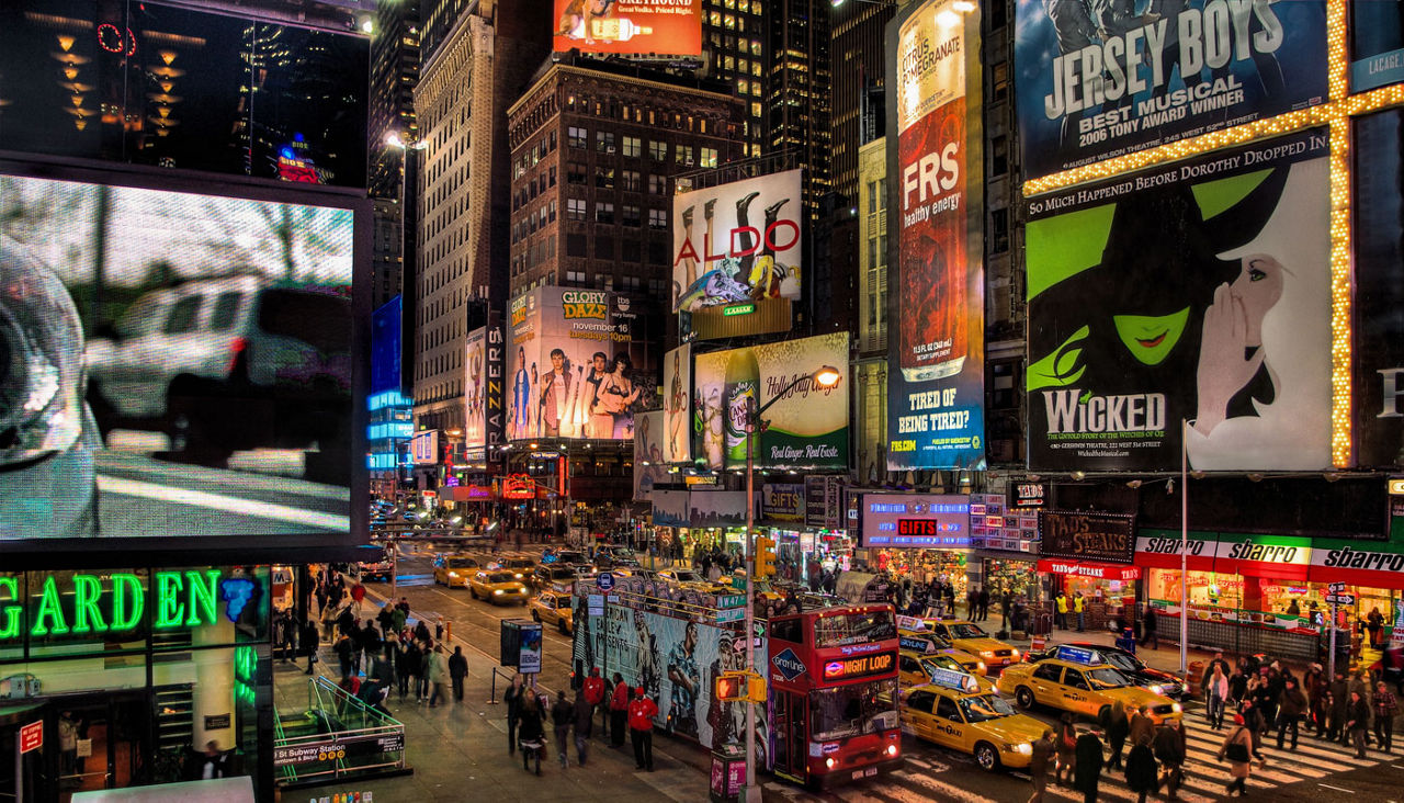 Times Square, New York City looking back toward billboards on Broadway at night