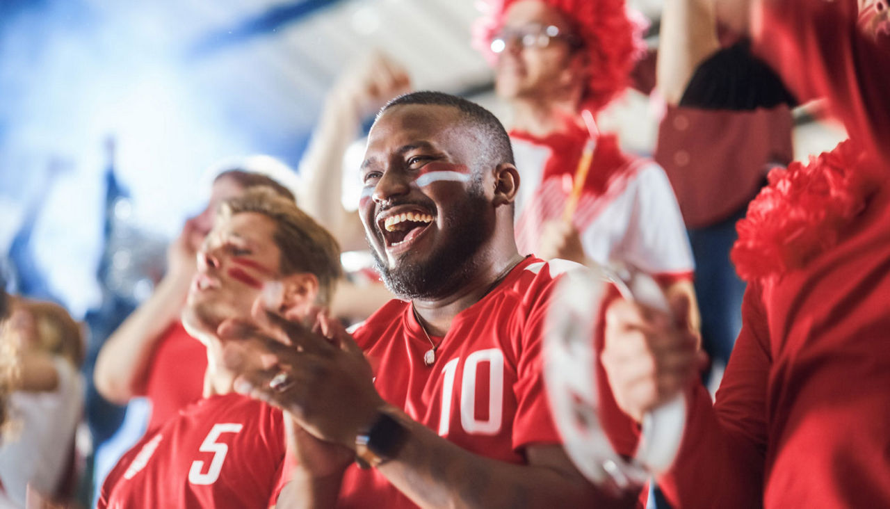 sports fans cheering at an event