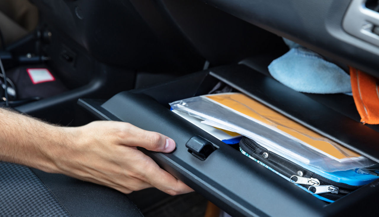 Driver Opening Glovebox Compartment