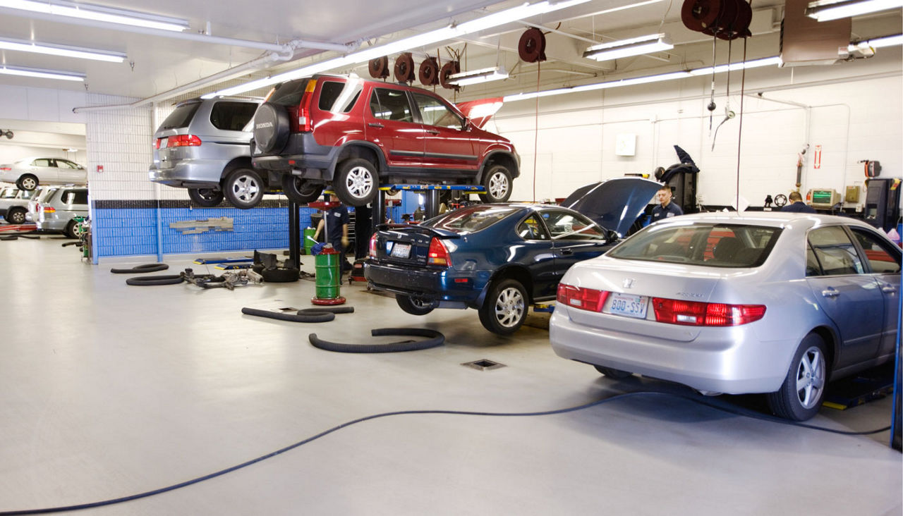 four cars in a repair shop 
