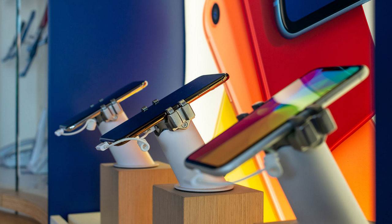 Cell Phones on shelf in telecommunication shop.