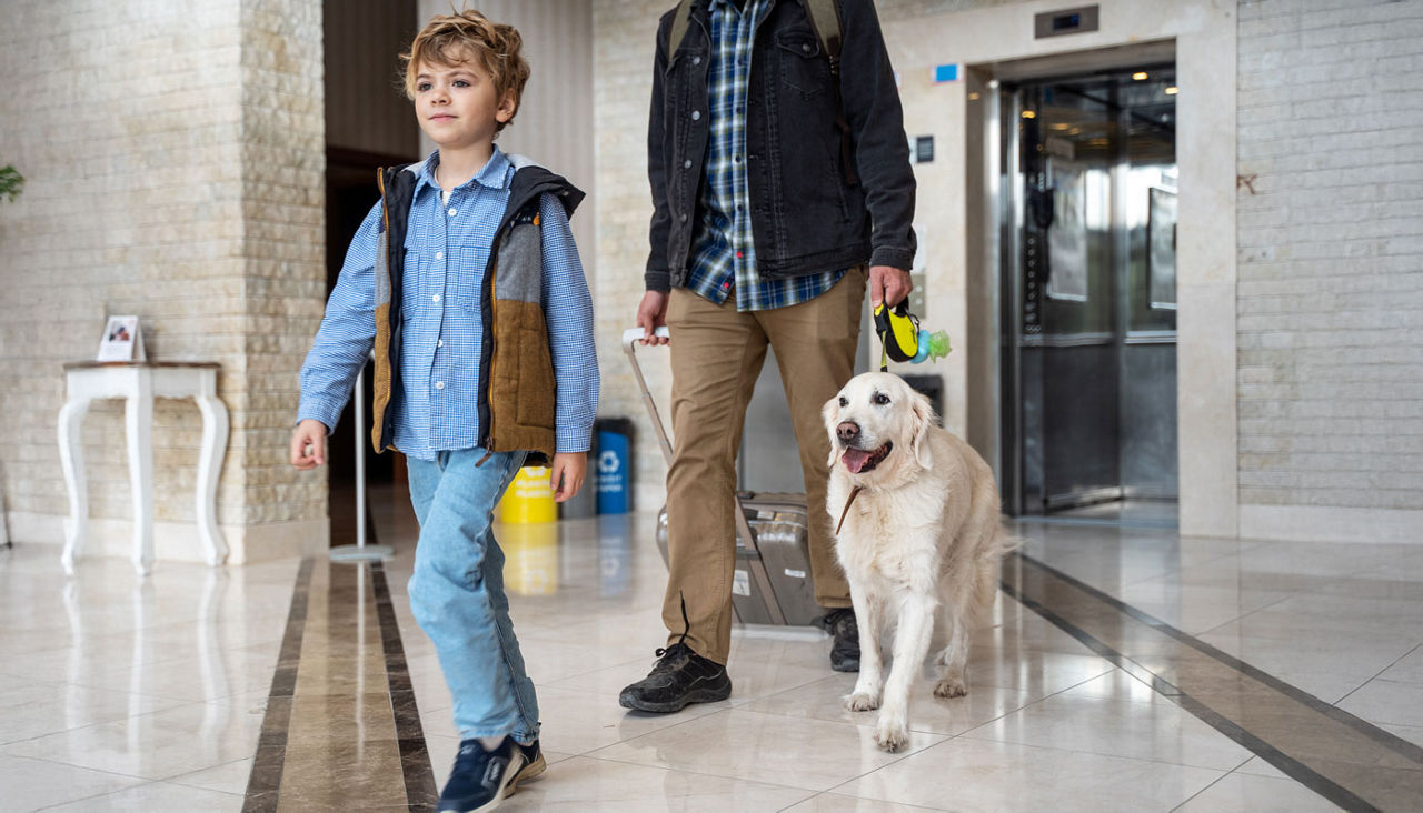 Family traveling with golden retriever dog