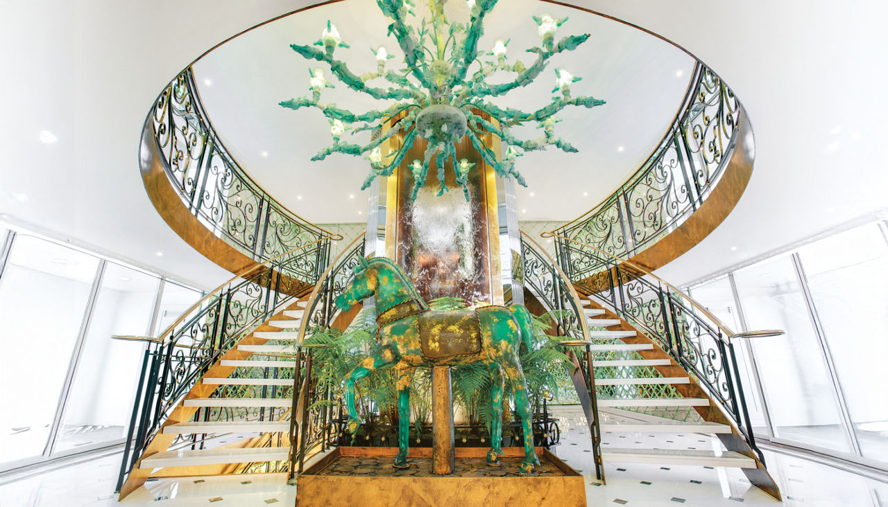 The opulent staircase on the S.S Catherine featuring a Murano glass chandelier