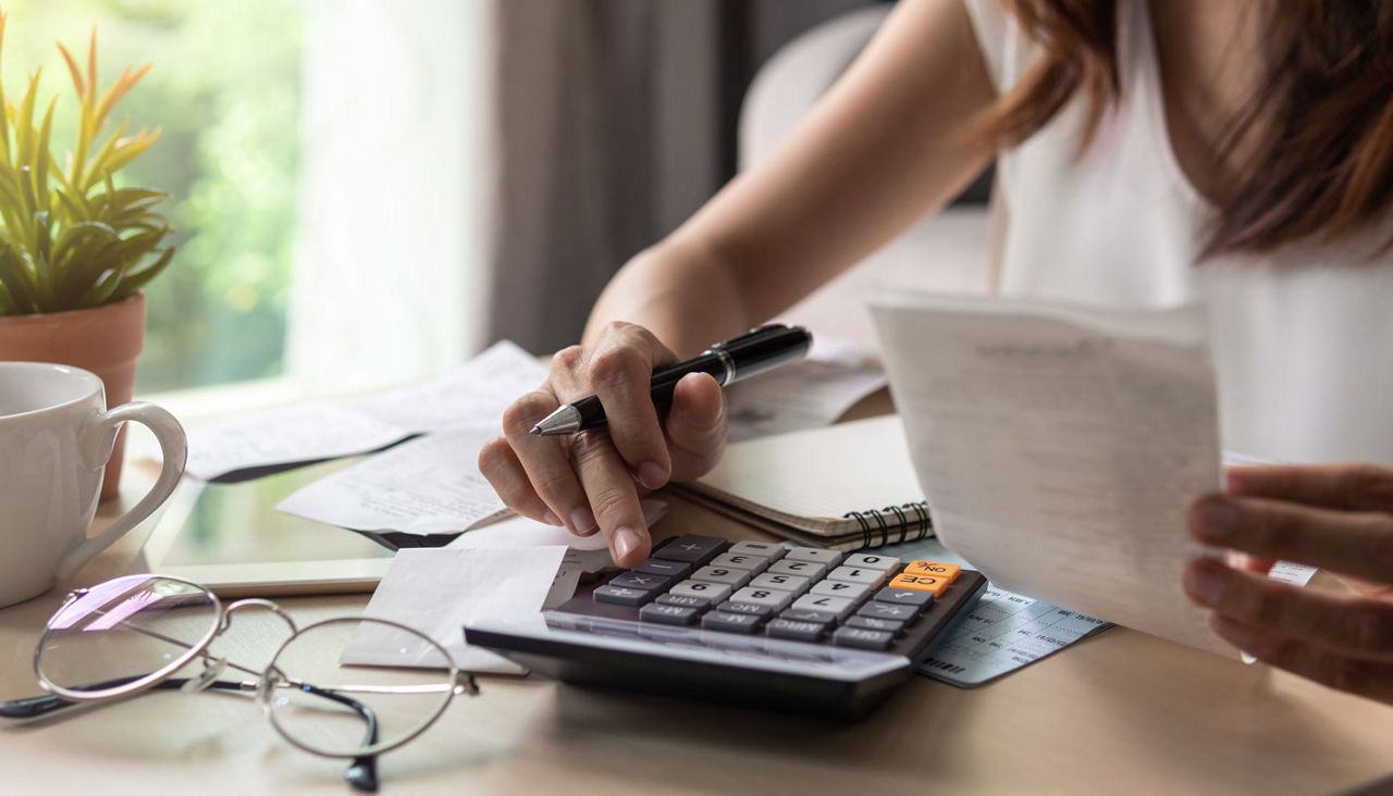 woman checking bills, taxes, bank account balance and calculating expenses