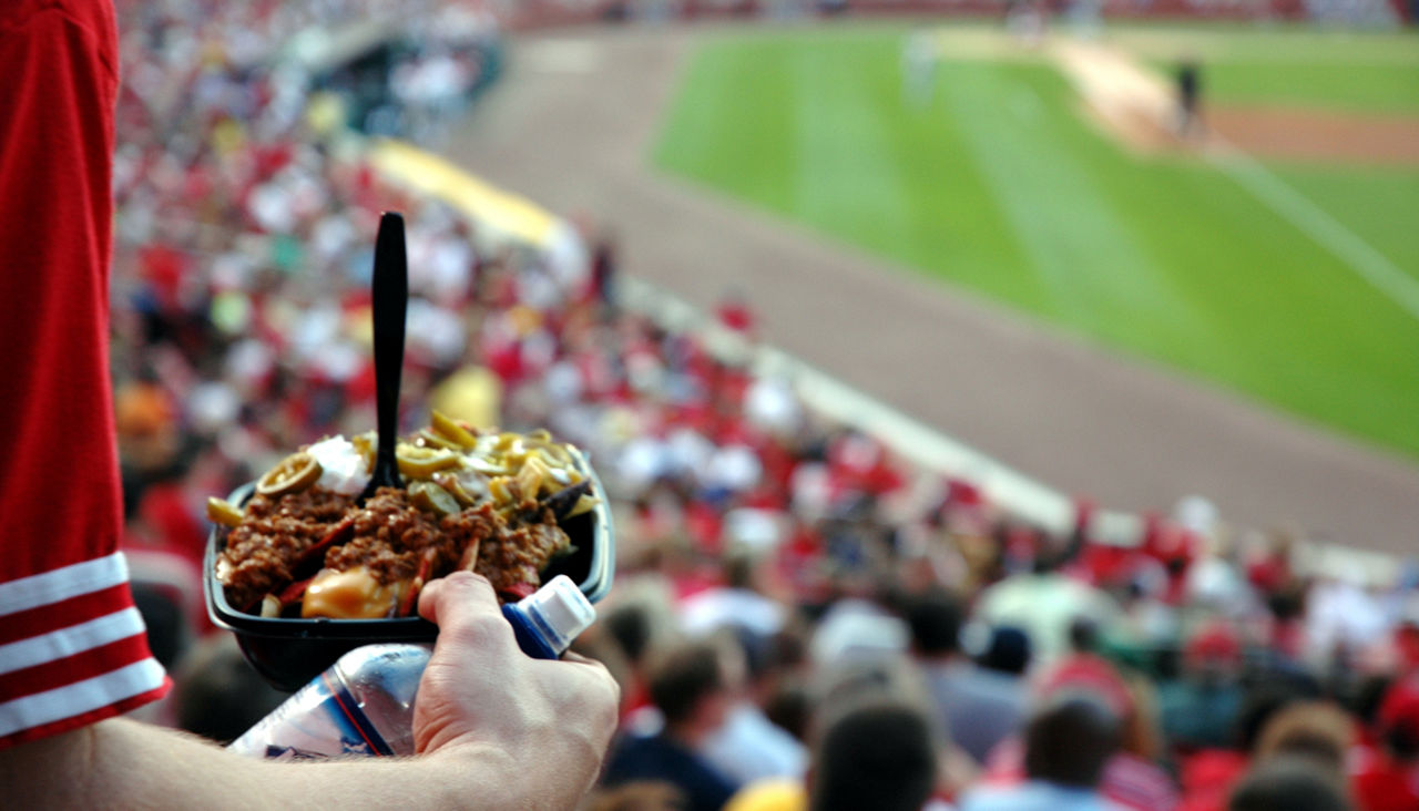 Fan holding food at a baseball stadium