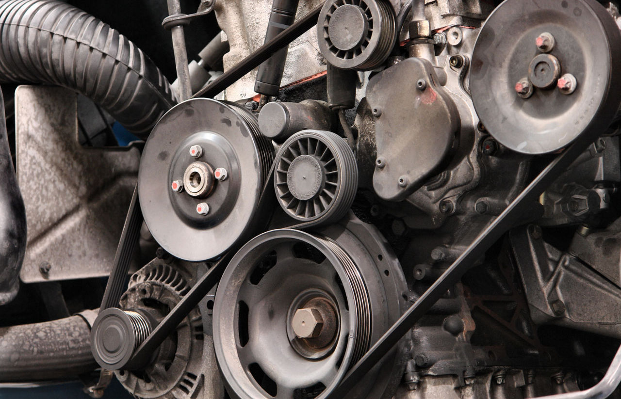 Car engine showing belts and hoses