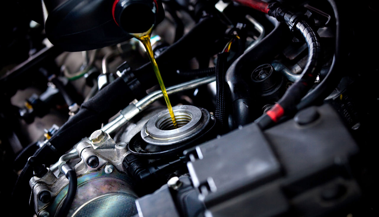 Oil being poured into car engine