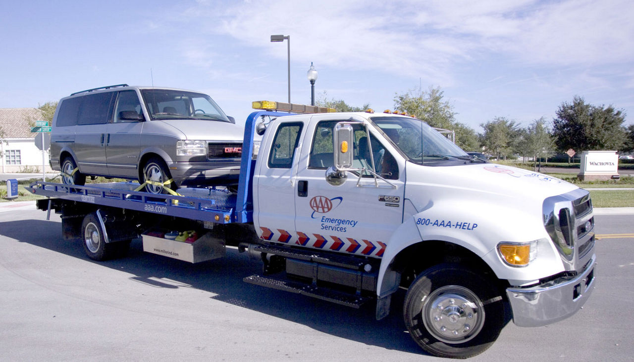 AAA Flatbed tow truck with van on board