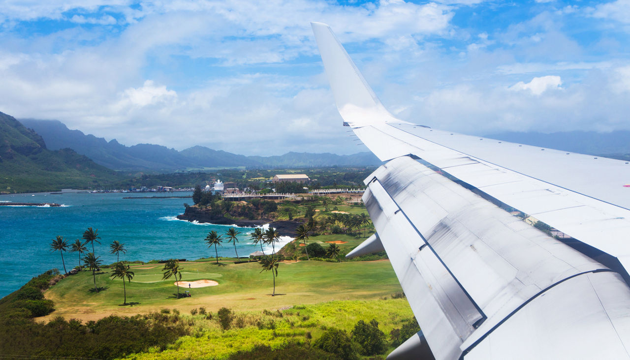 A plane flies into Lihue airport on Kauai
