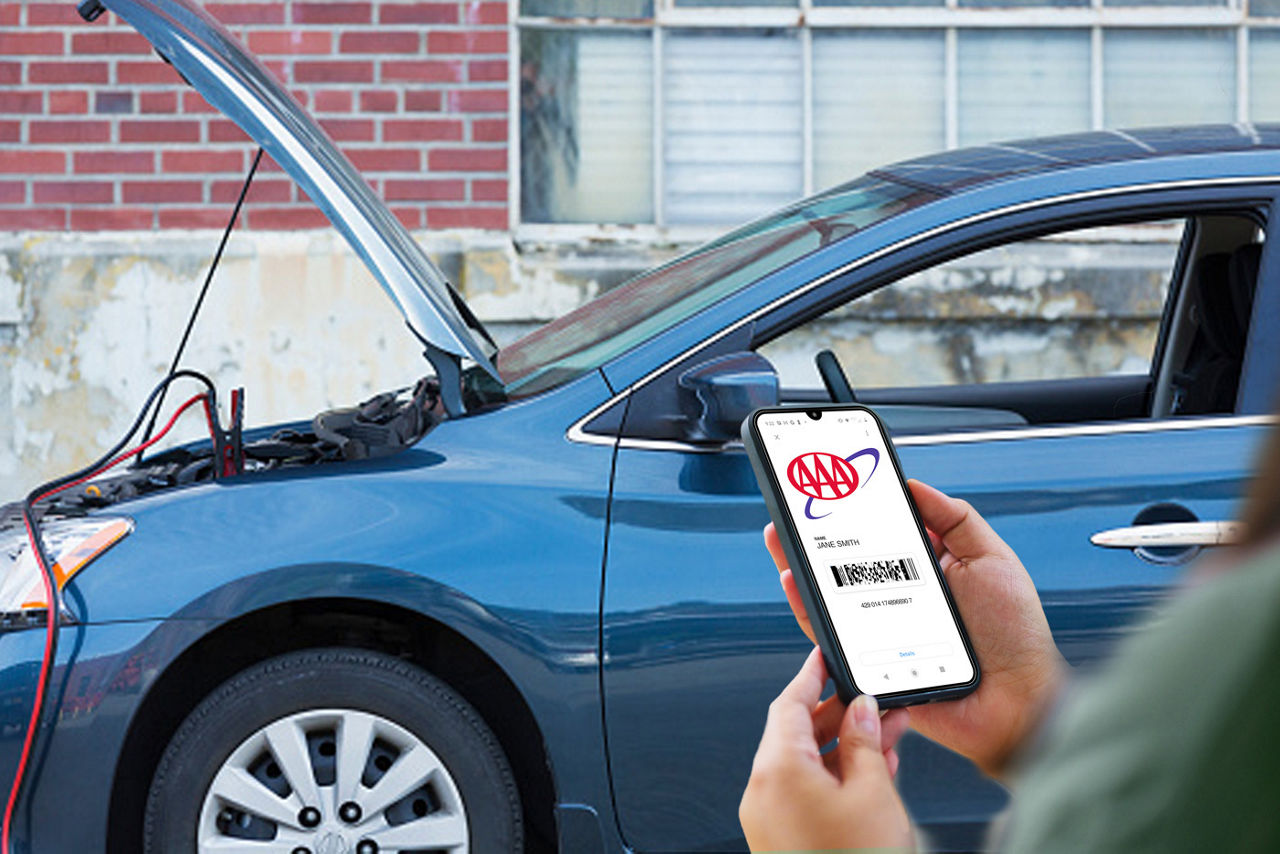 woman holding phone with AAA Membership and broken down car in background