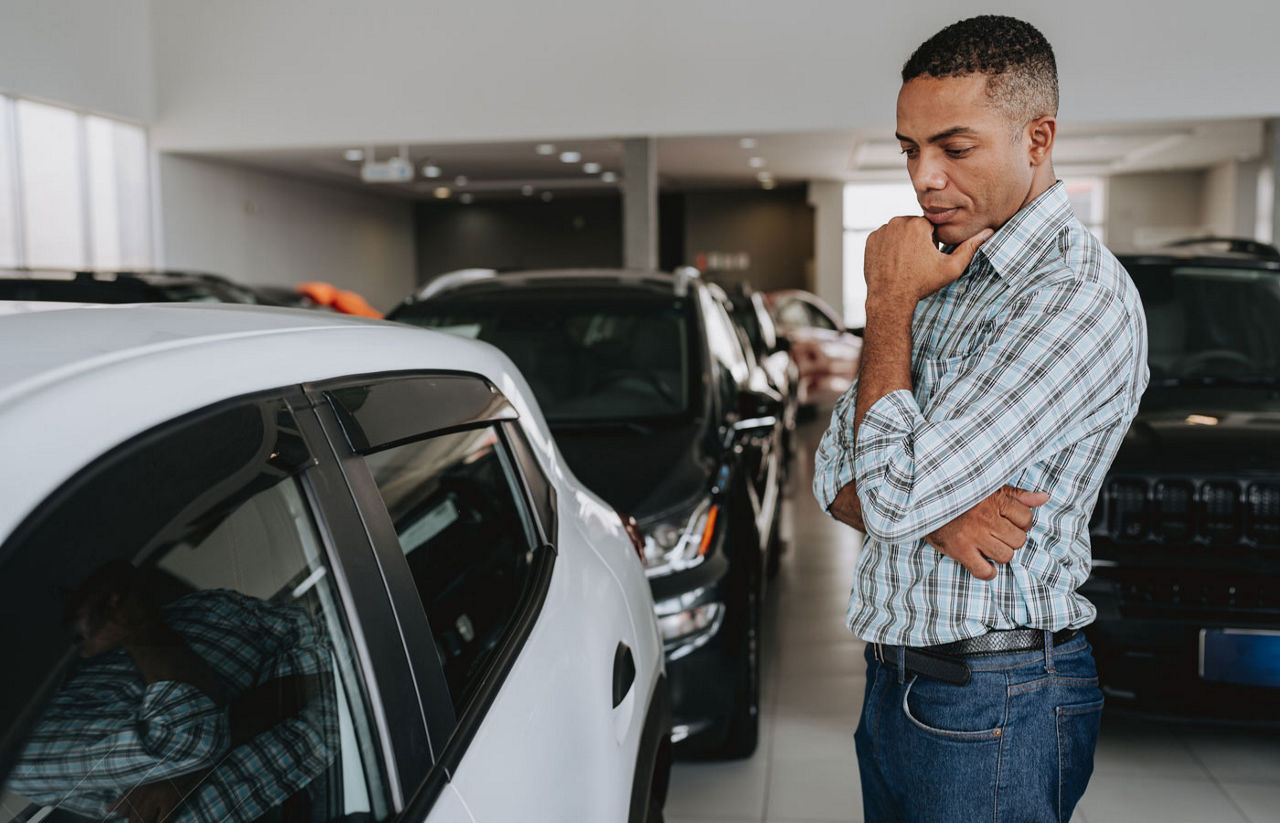 Man analyzing car to buy