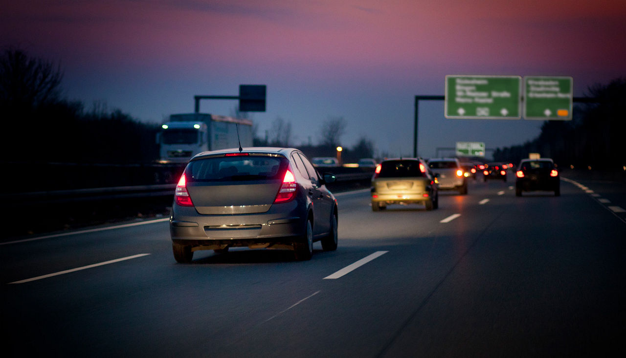 Multiple cars driving on interstate at dusk