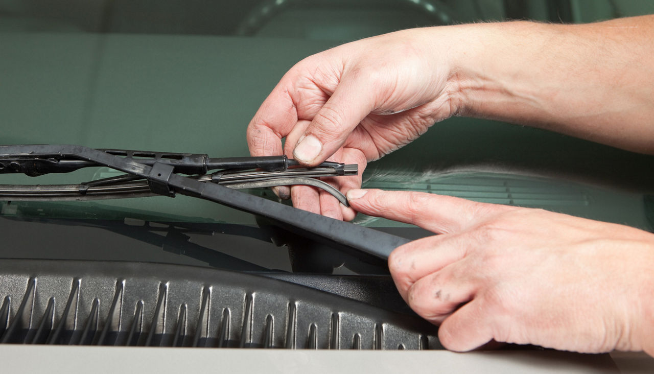 Mechanic’s Hand Holding Broken Windshield Wiper Blade