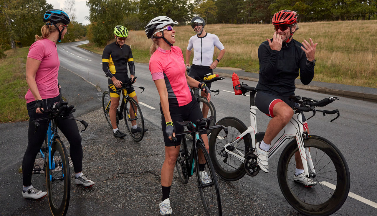 Group of cyclists relaxing on roadside