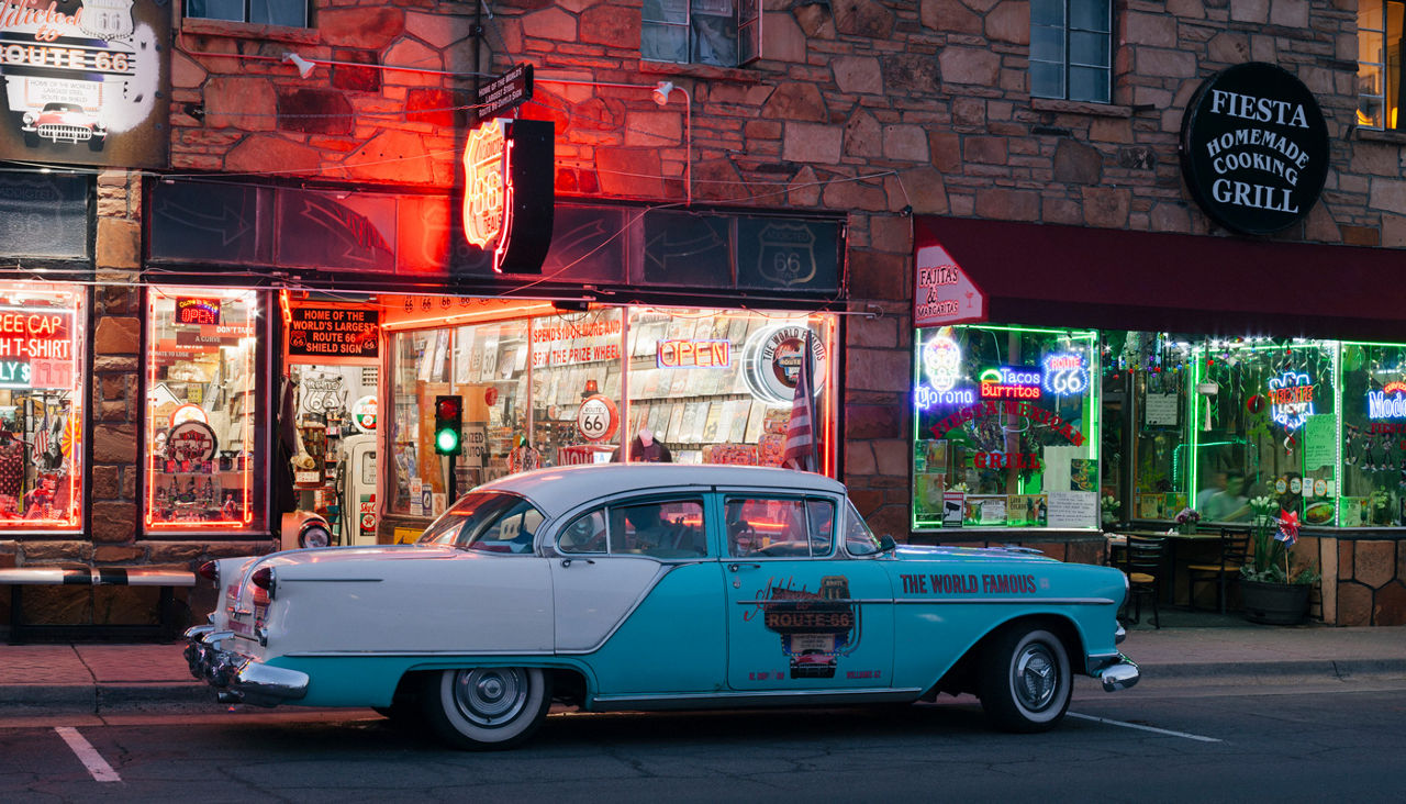 Classic car and neon signs in Williams at night along Route 66
