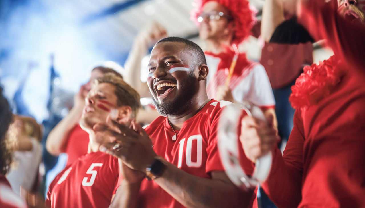 Group of fans at a football game in their favorite game gear