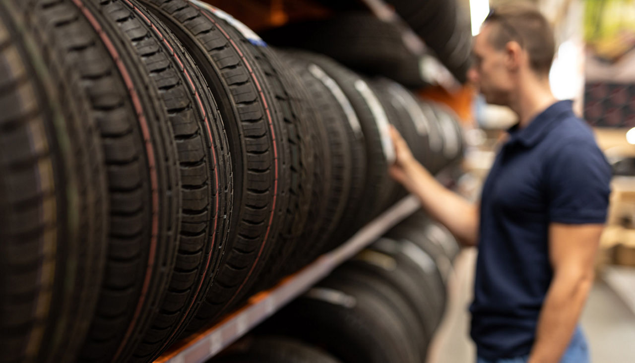 Man chooses car tires on a showcase