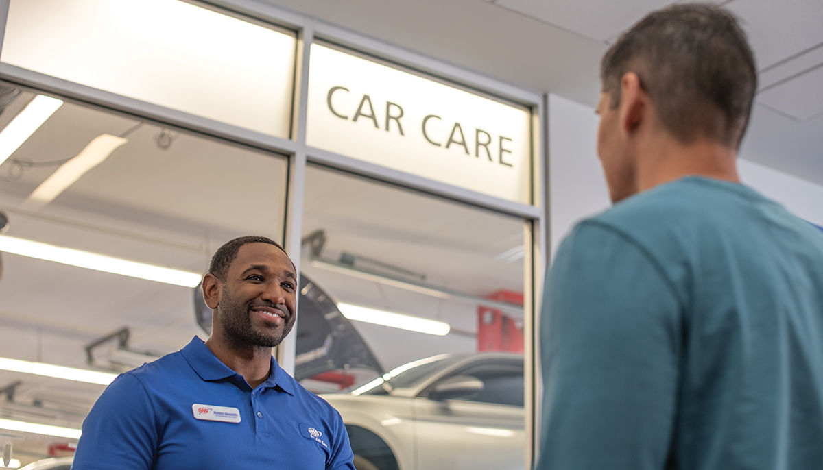 Car Care employee talking to customer