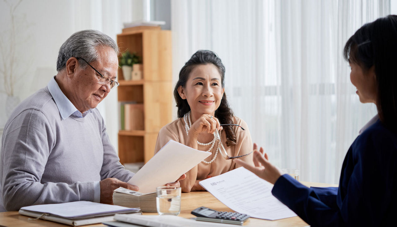 senior couple consulting with a will and trust agent