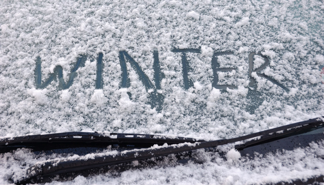 Winter written on a snow covered window