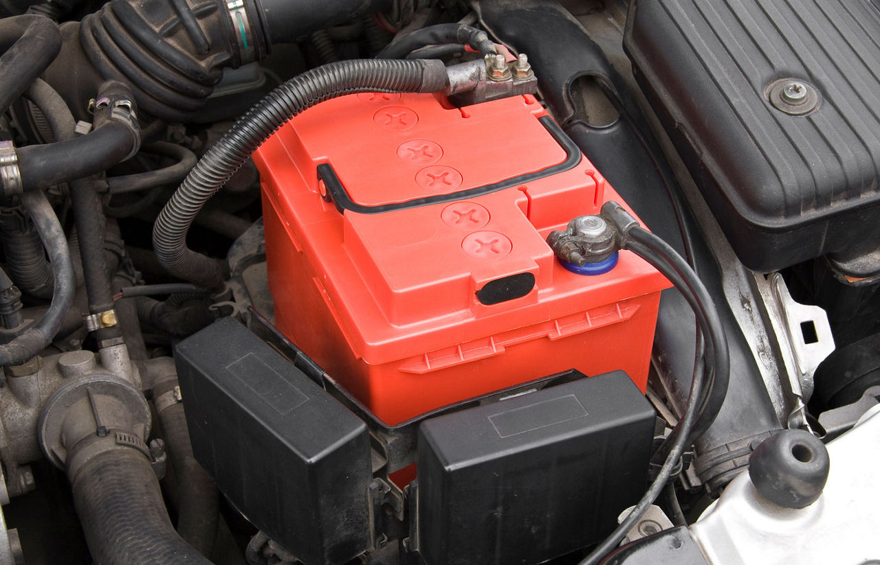 red car battery inside engine