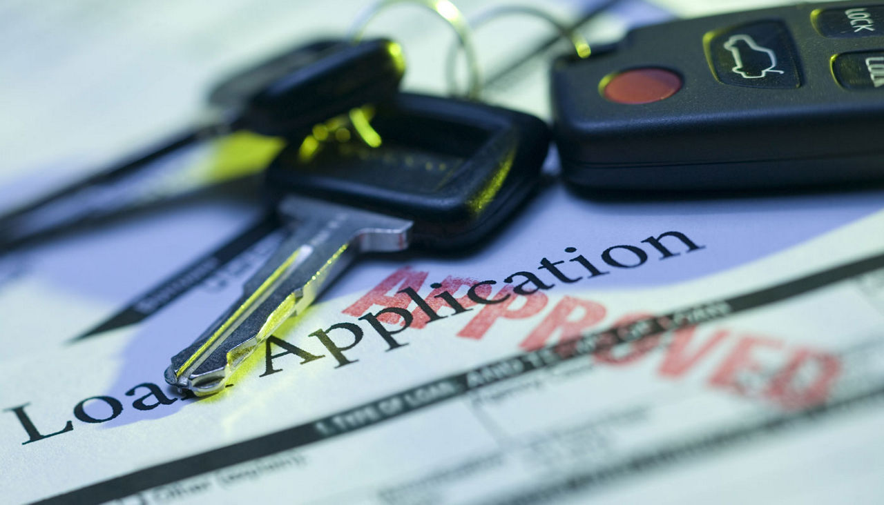 car keys on top of loan application 