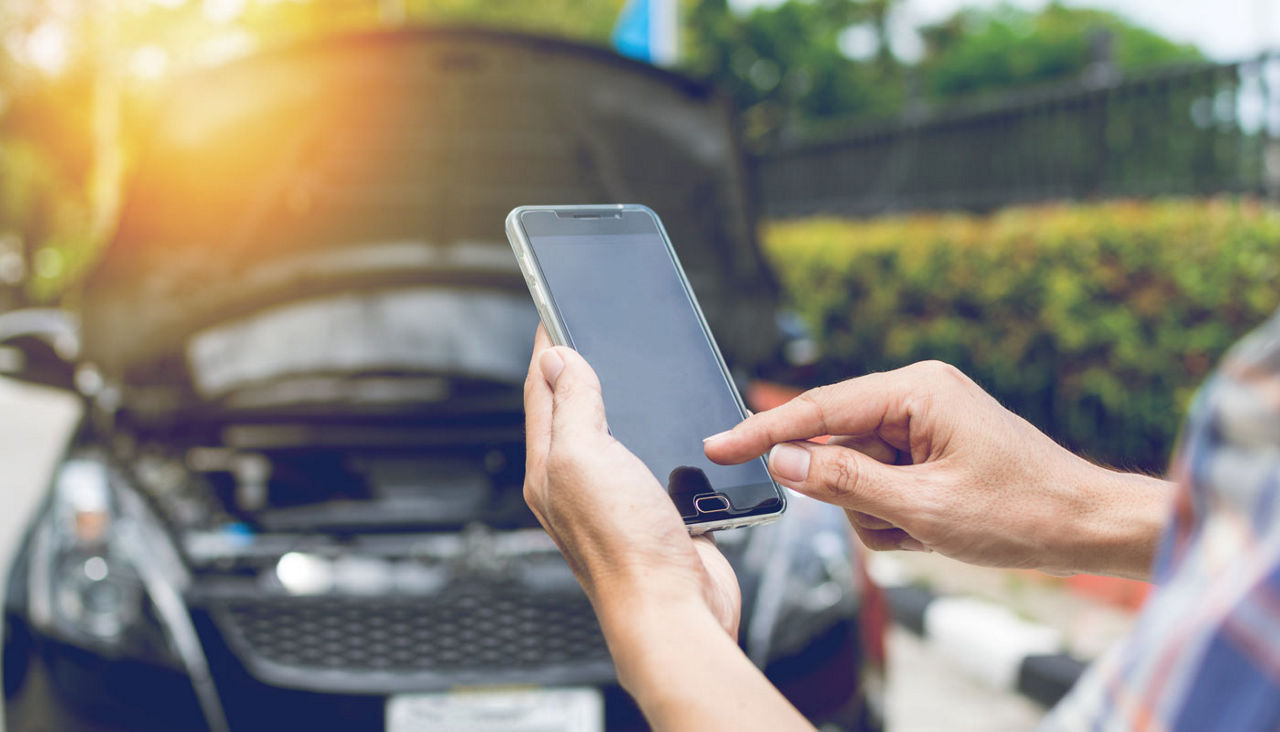 Man Phoning For Help with a broken down car