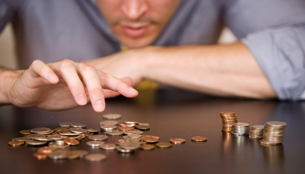 male counting coins