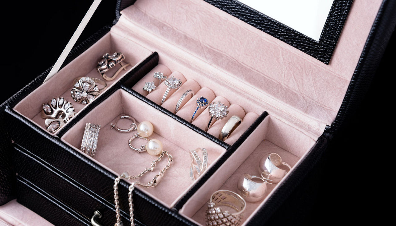 Jewelry box with white gold and silver rings, earrings and pendants with pearls. Collection of luxury jewelry.