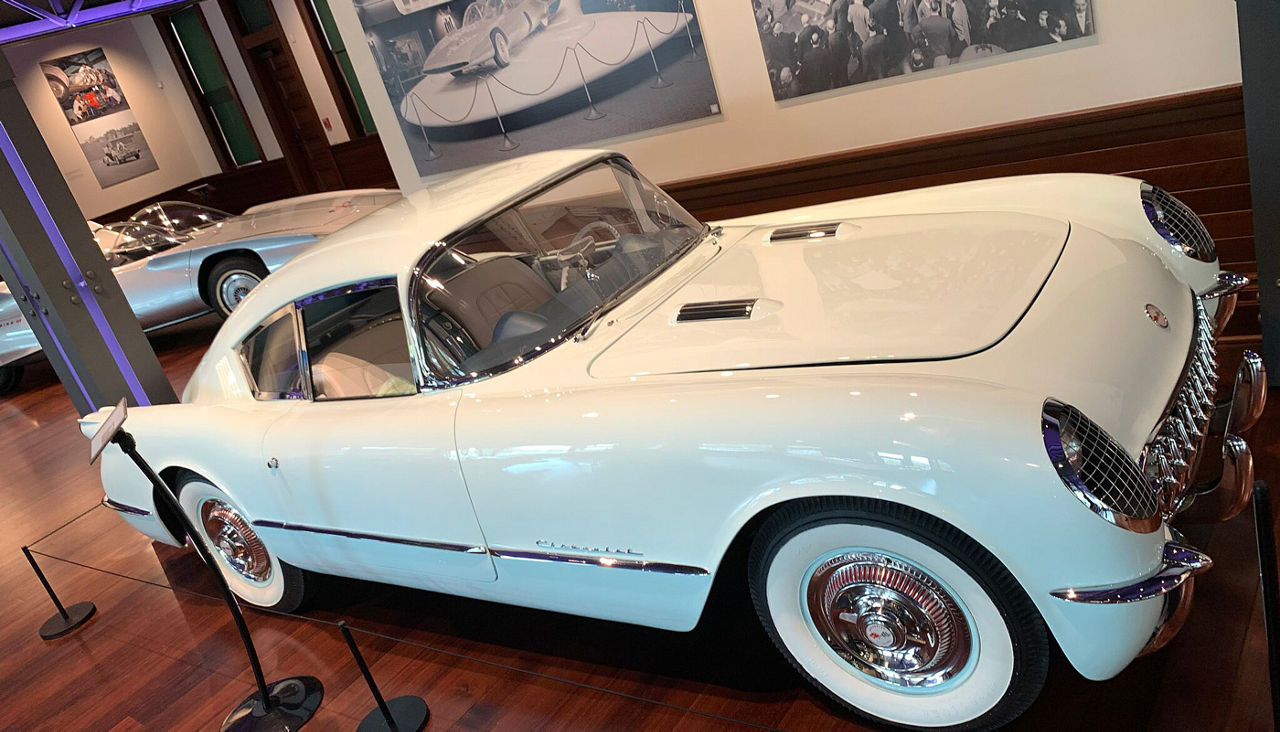 A view of a white antique car in the Ypsilanti Automotive Museum