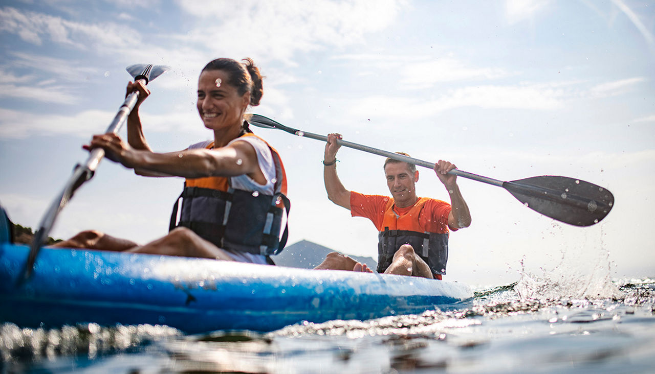 Two people in a kayak paddling