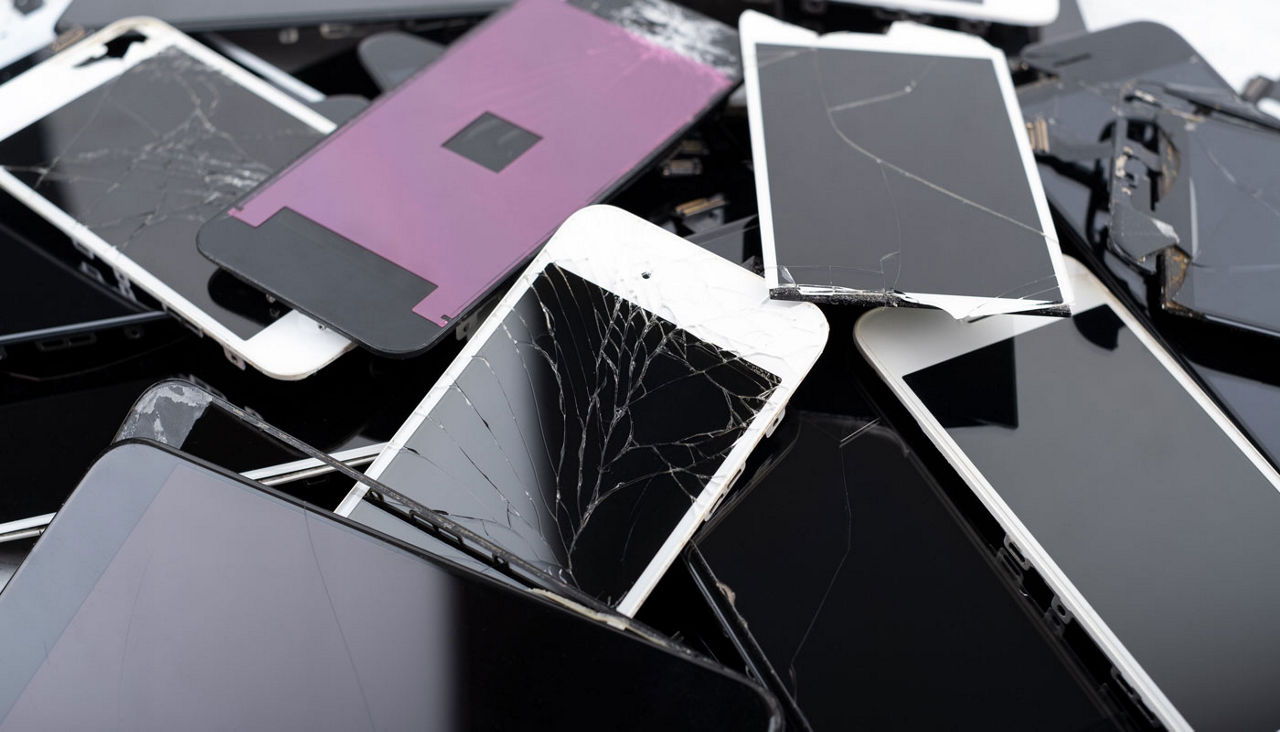 Pile of broken and cracked phone screens