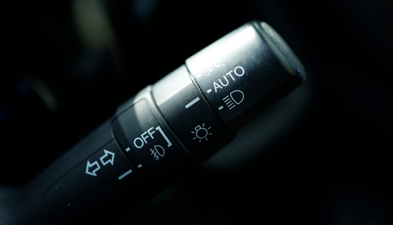 Close-up of a headlight switch in a car.