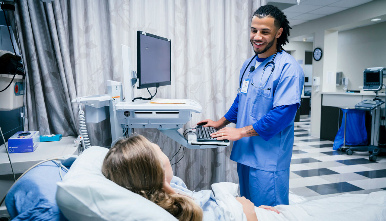 Nurse talking to patient in hospital bed