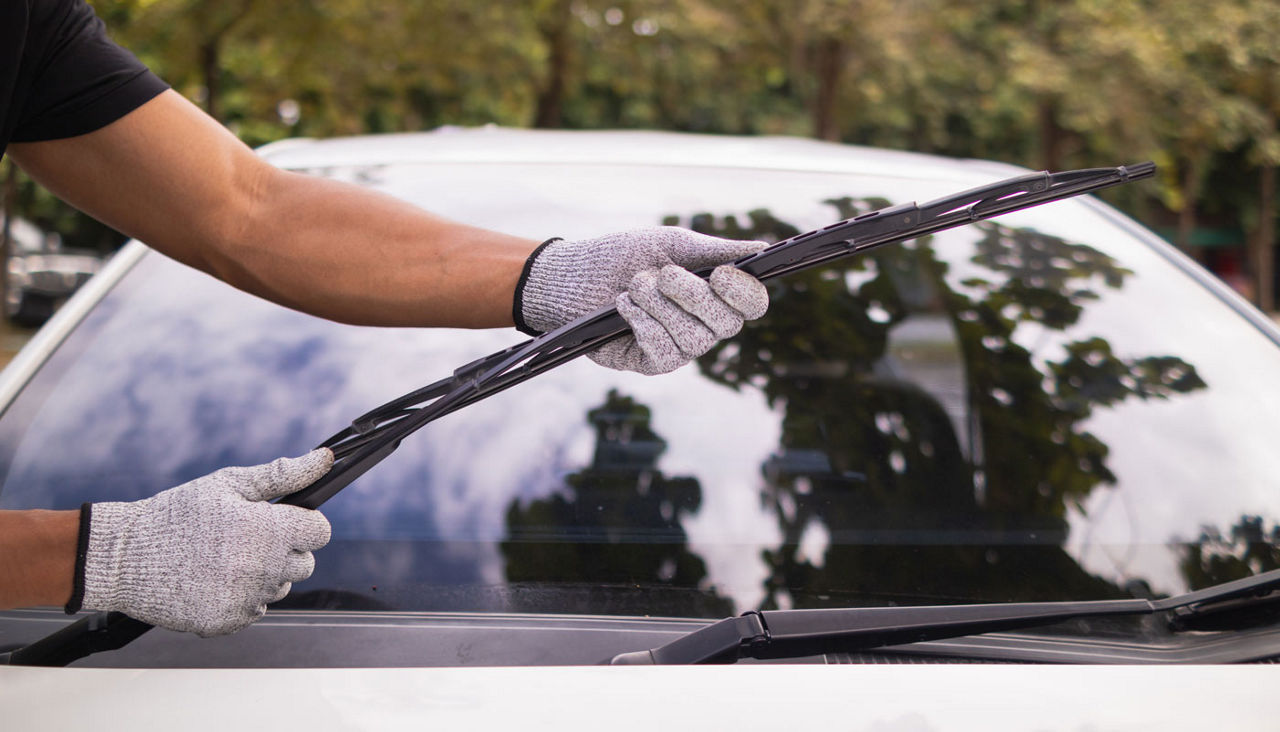 mechanic is checking car wiper blades to replace new wiper blades for car