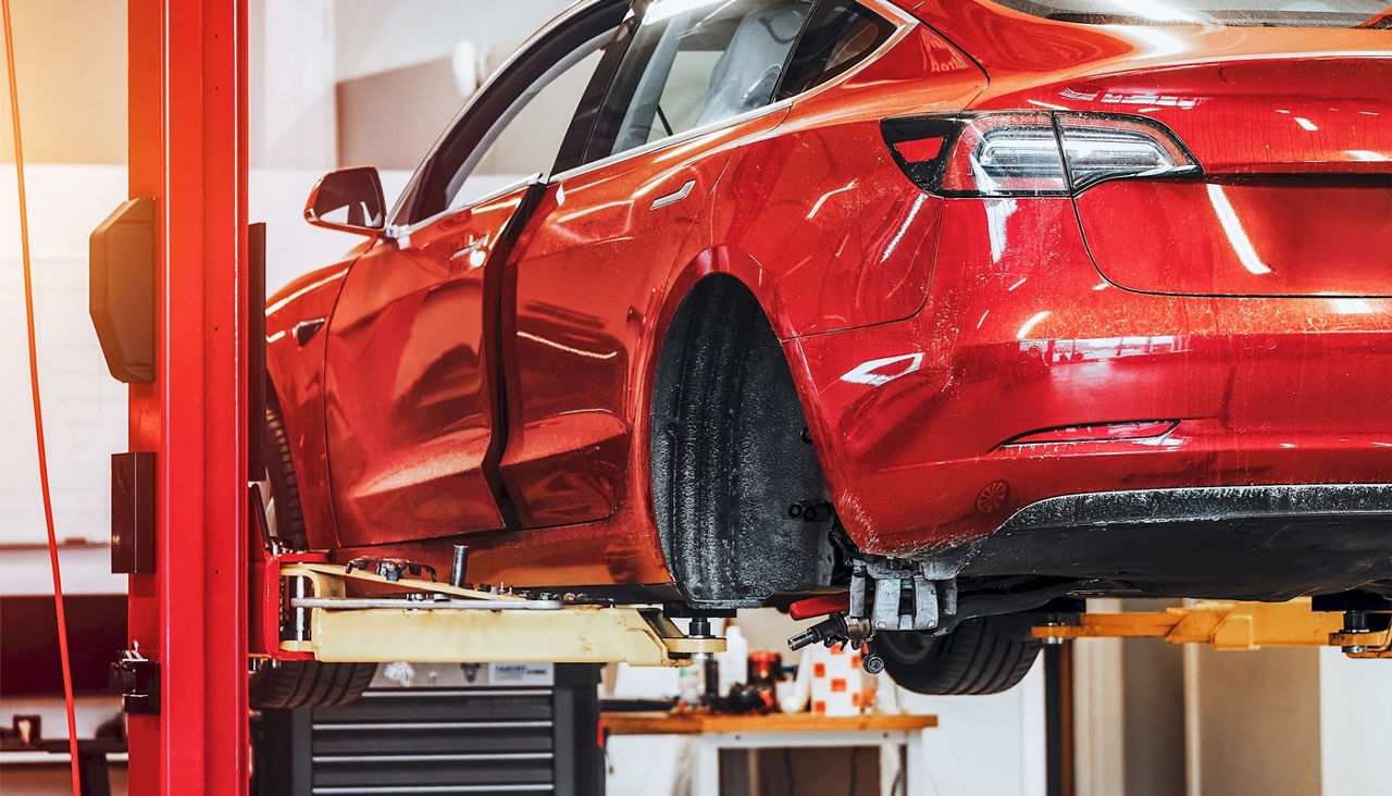 Electric vehicle in professional shop for body damage