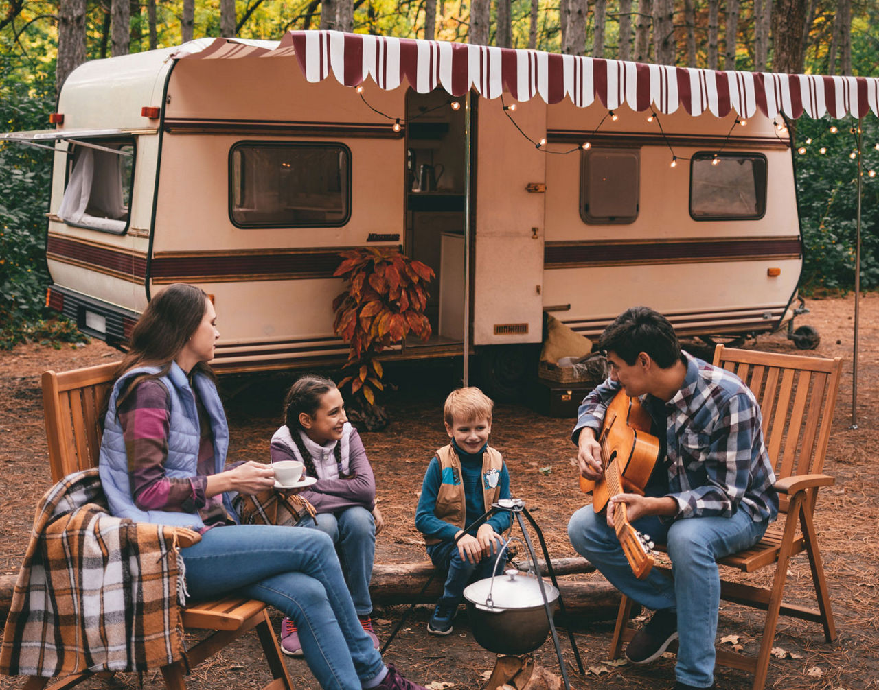 Family on a camping trip relaxing in the autumn forest