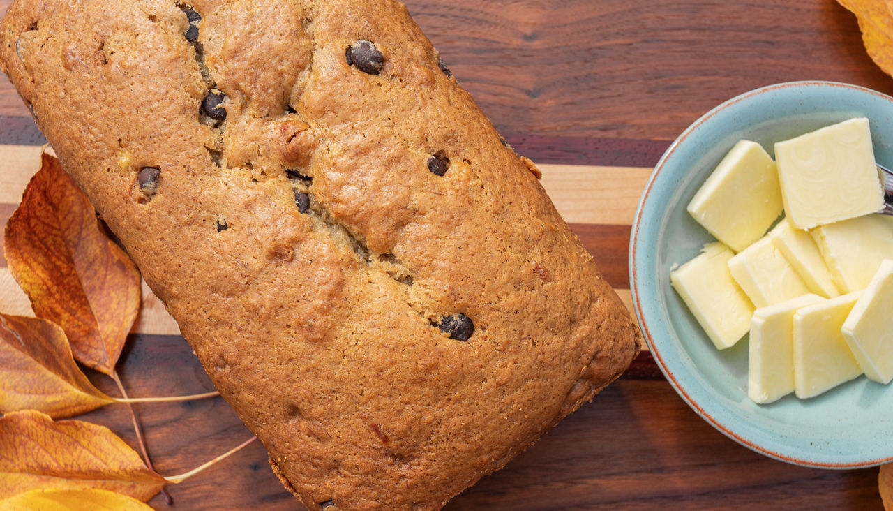 Up close view of banana bread with butter nearby